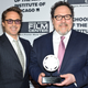 Jon Favreau receives his Renaissance Award at the 2019 Gene Siskel Film Center Gala, with BFF Robert Downey Jr. by his side